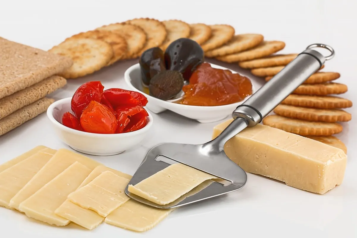cheese slicer, crackers, appetizers, dairy product, protein, finger food, snack, hors d'oeuvre, sliced, cut, diet, food, biscuits, nutrition, buffet, platter, n